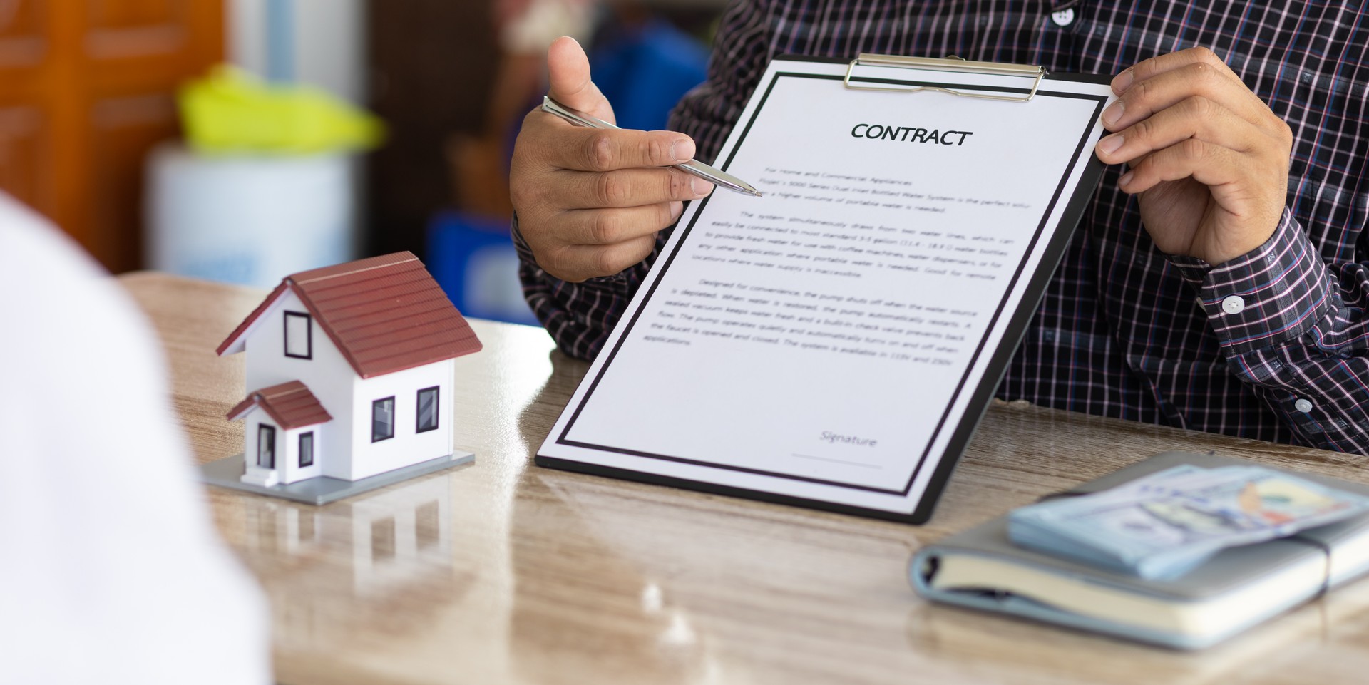 Real estate agents discuss home and land purchases with customers after agreeing to a home purchase and loan agreement.